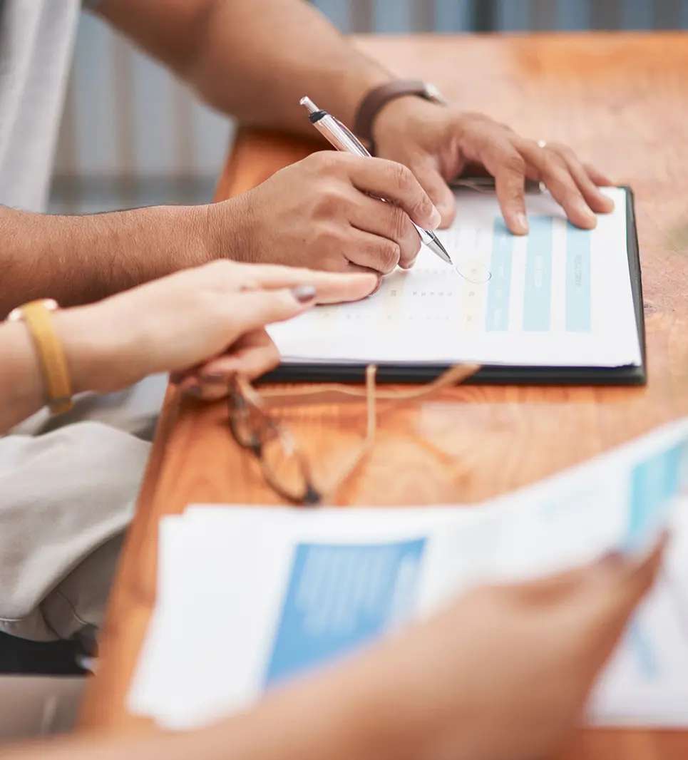 Team discussing paperwork outdoors