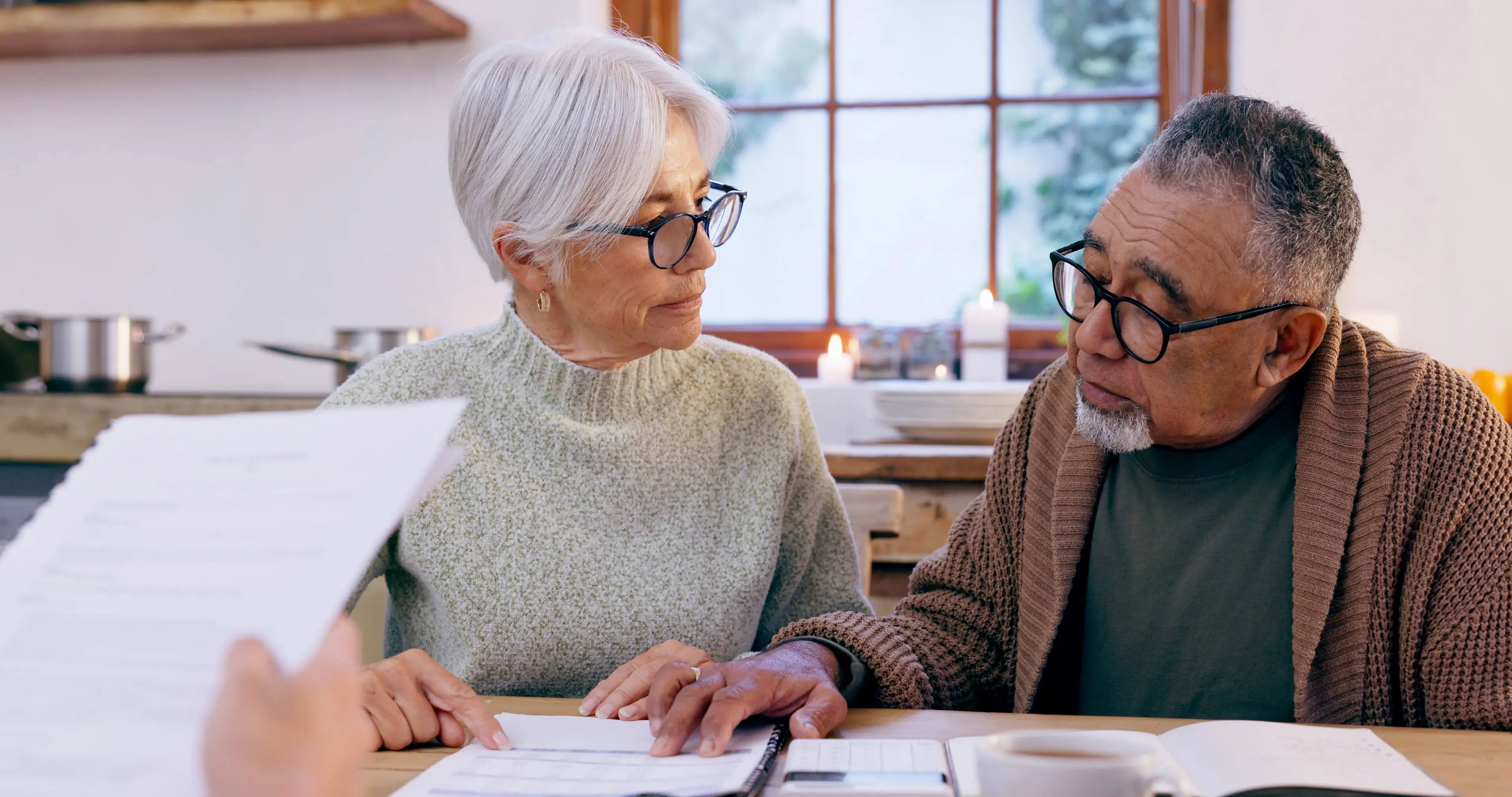 Couple, documents and reading for insurance in retirement, planning and bills or paperwork. Senior .