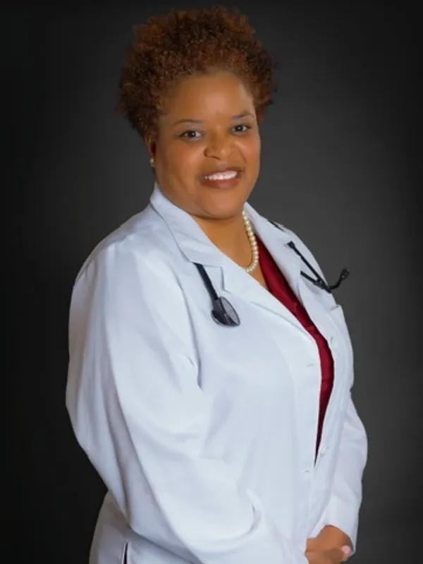 Woman doctor portrait against dark background