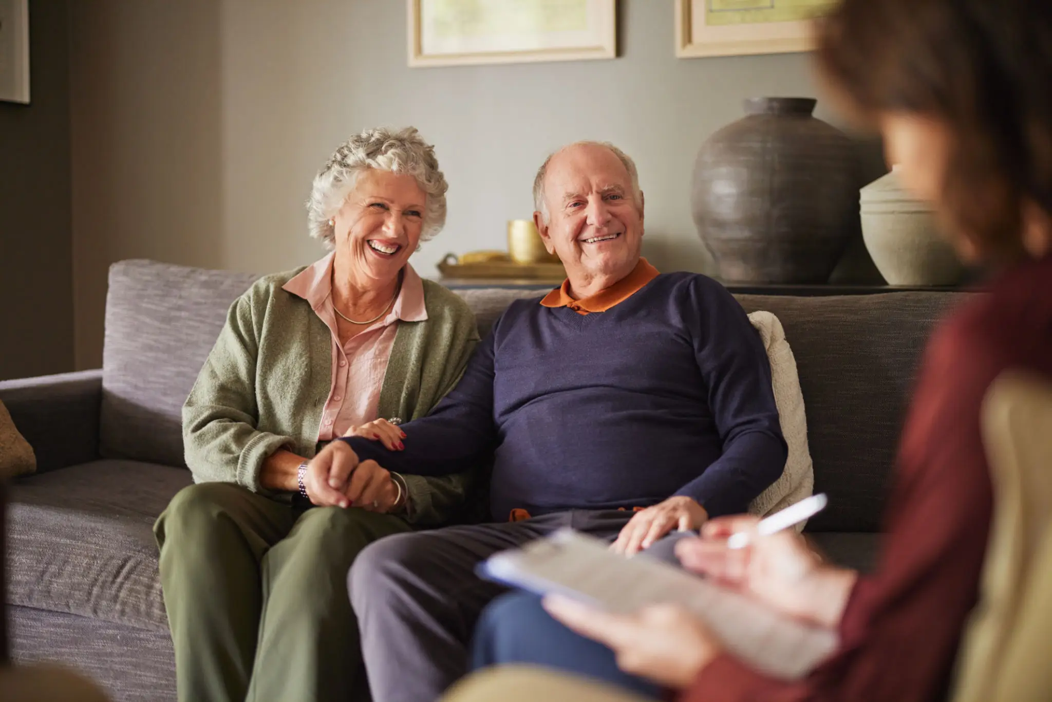 Happy elderly couple enjoying a conversation at home.